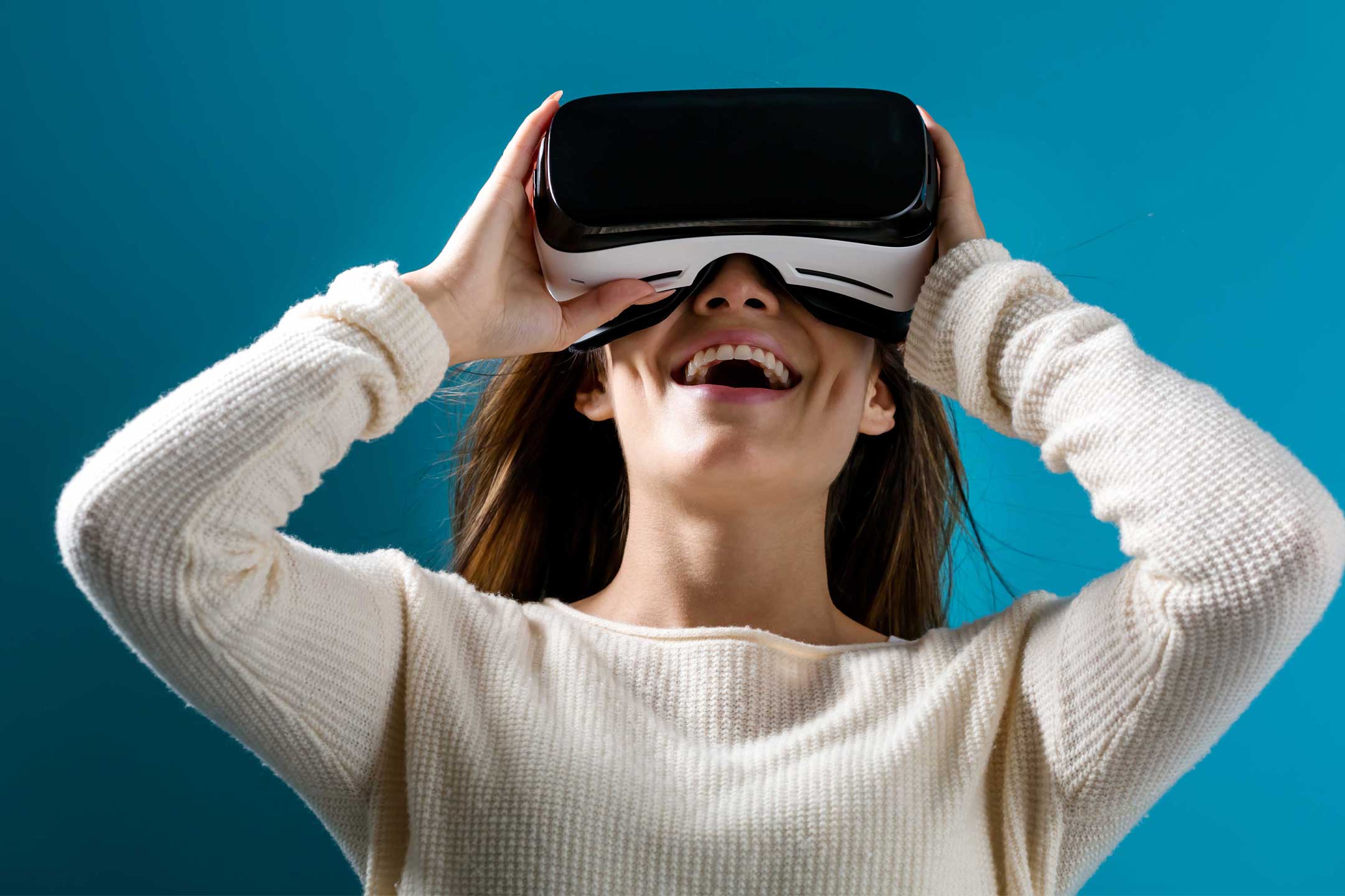 Woman smiling while looking through virtual reality headset